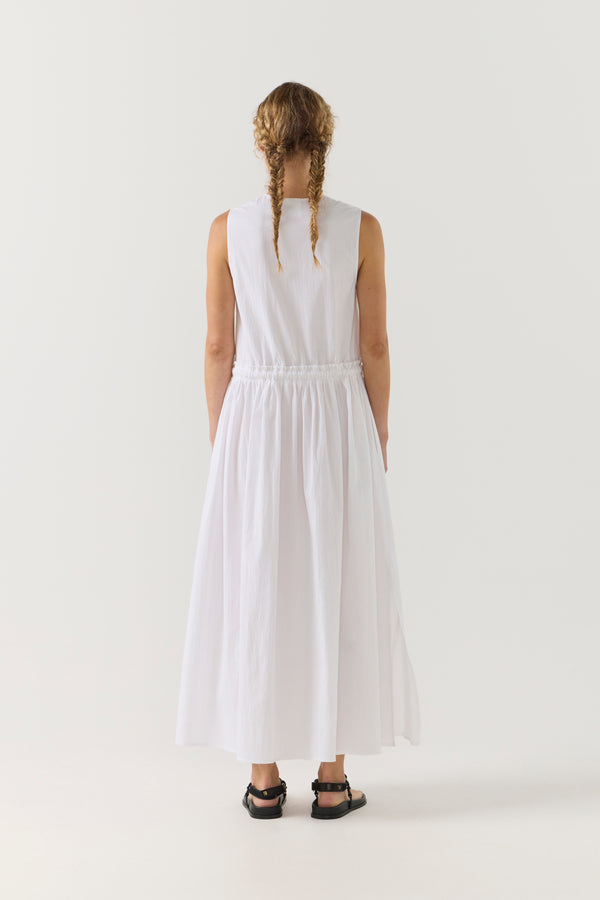 Woman wearing a white sleeveless dress on a white background
