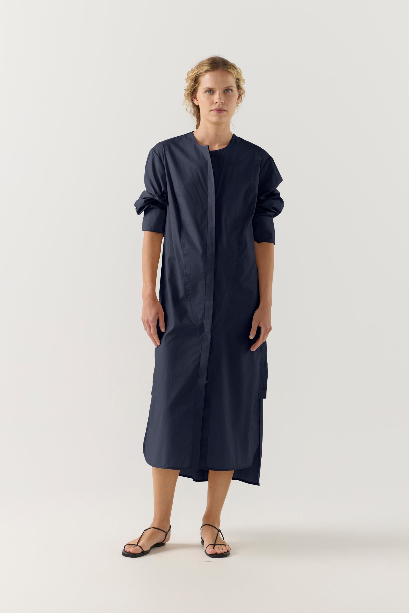 Woman wearing a dark blue dress on a white background