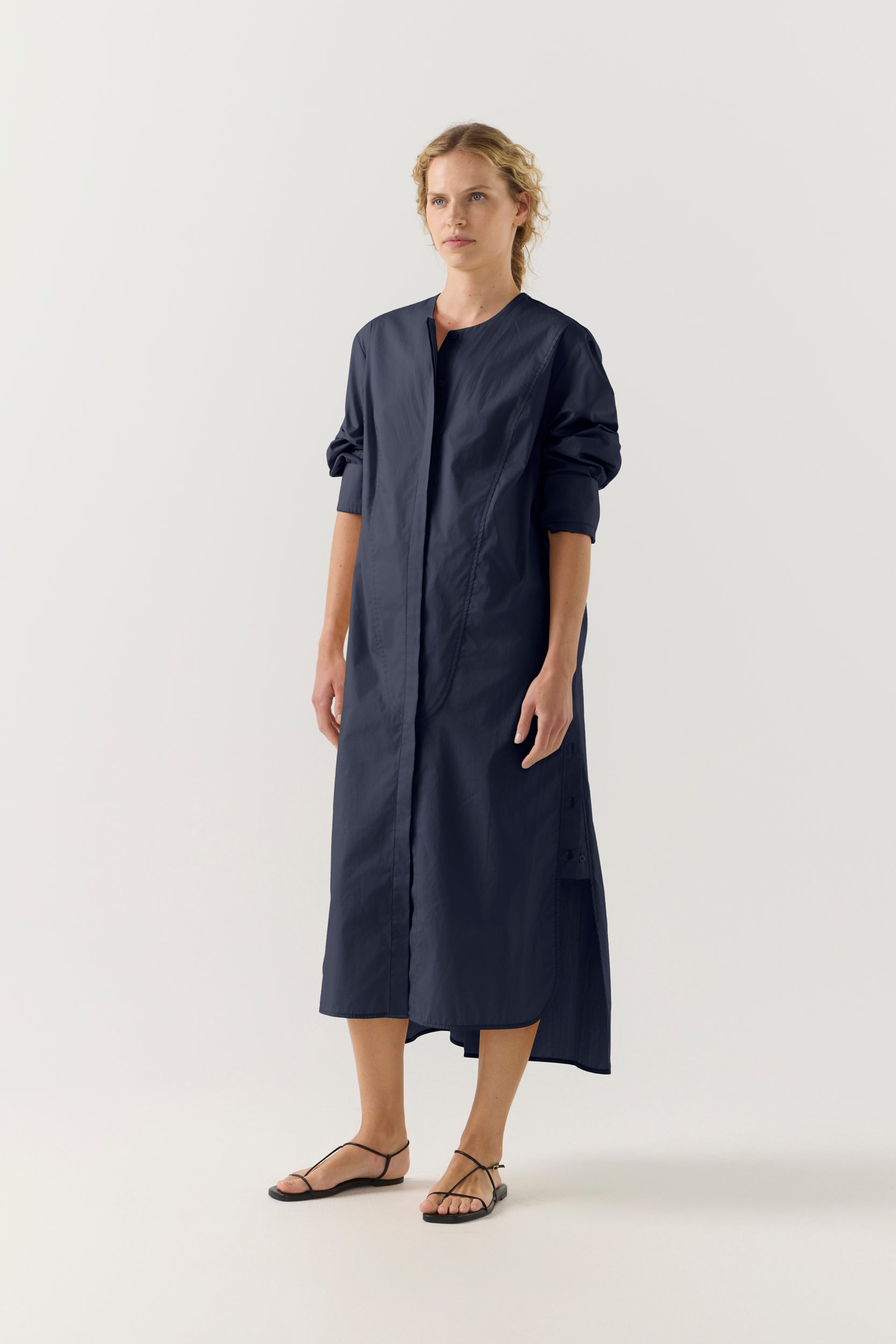 Woman wearing a dark blue dress on a white background