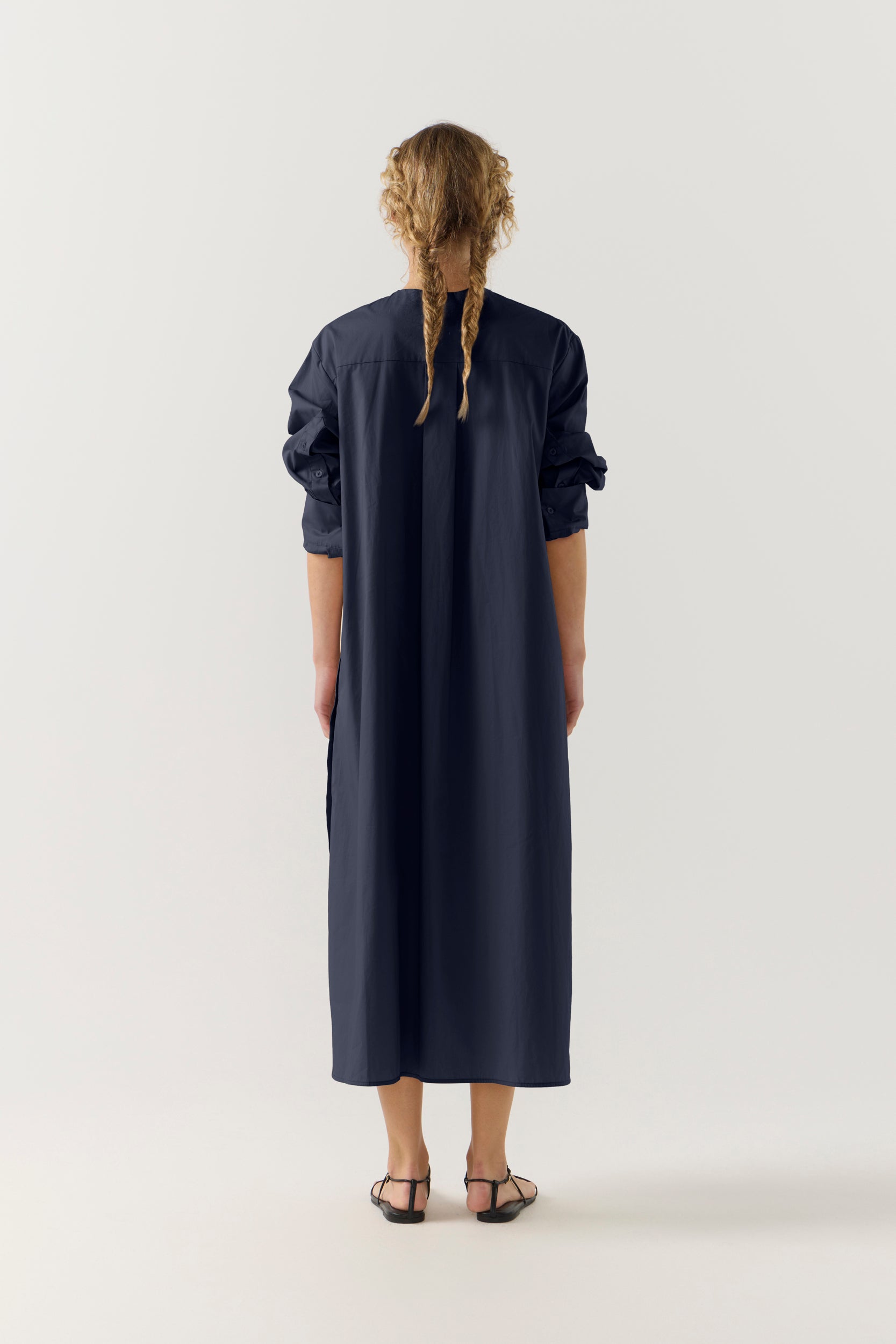 Woman wearing a dark blue dress on a white background