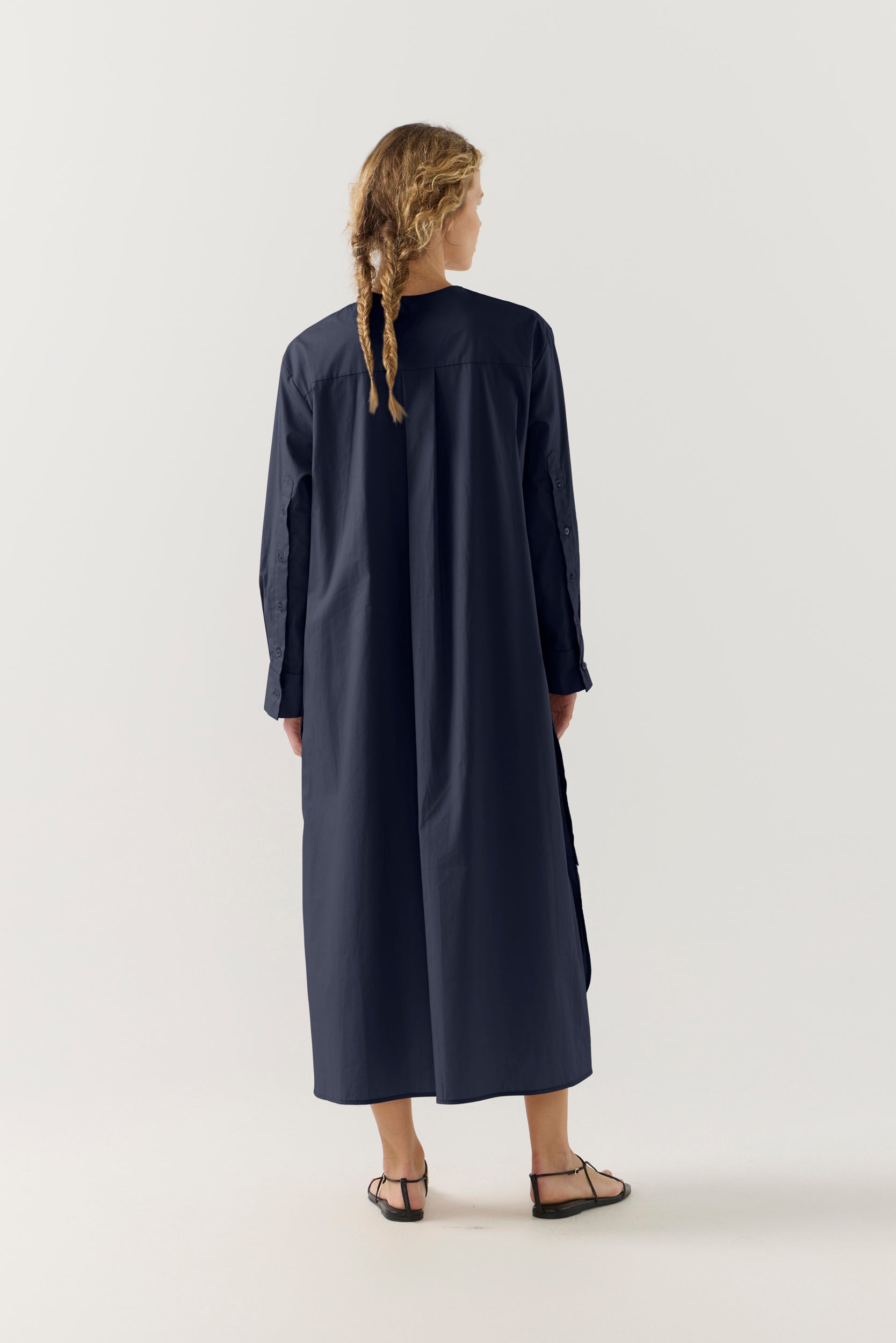 Woman wearing a dark blue dress on a white background