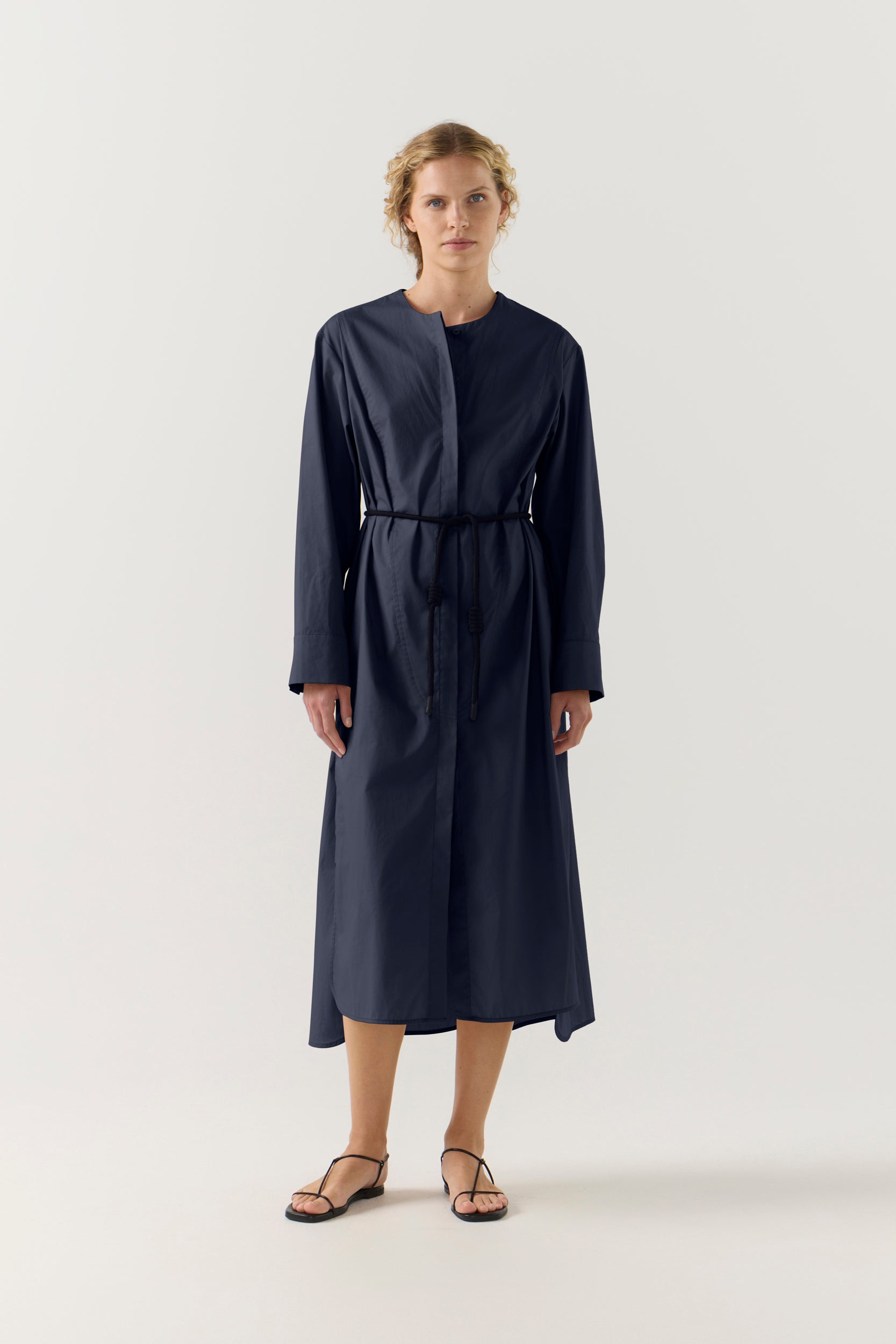 Woman wearing a dark blue dress on a white background