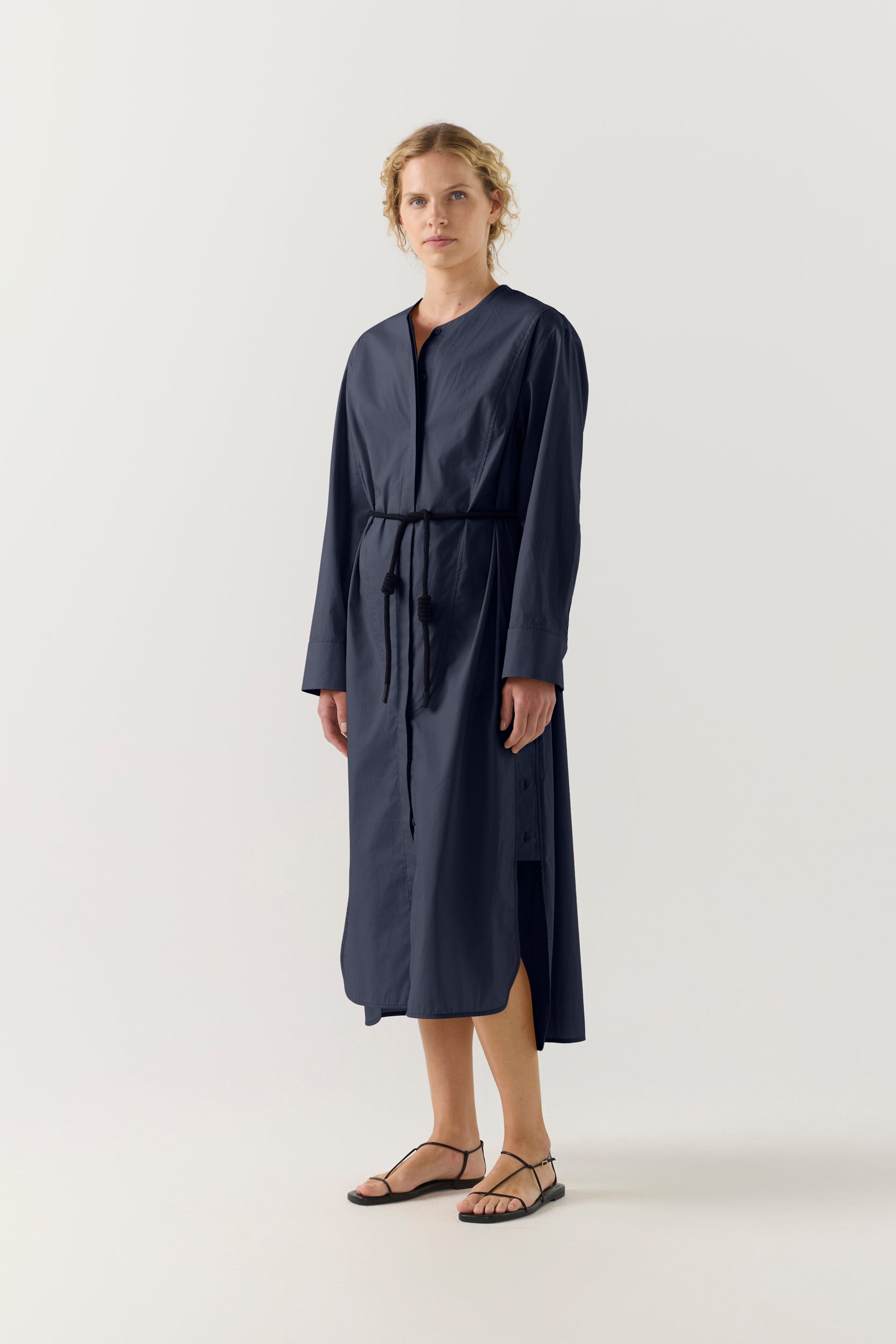 Woman wearing a dark blue dress on a white background