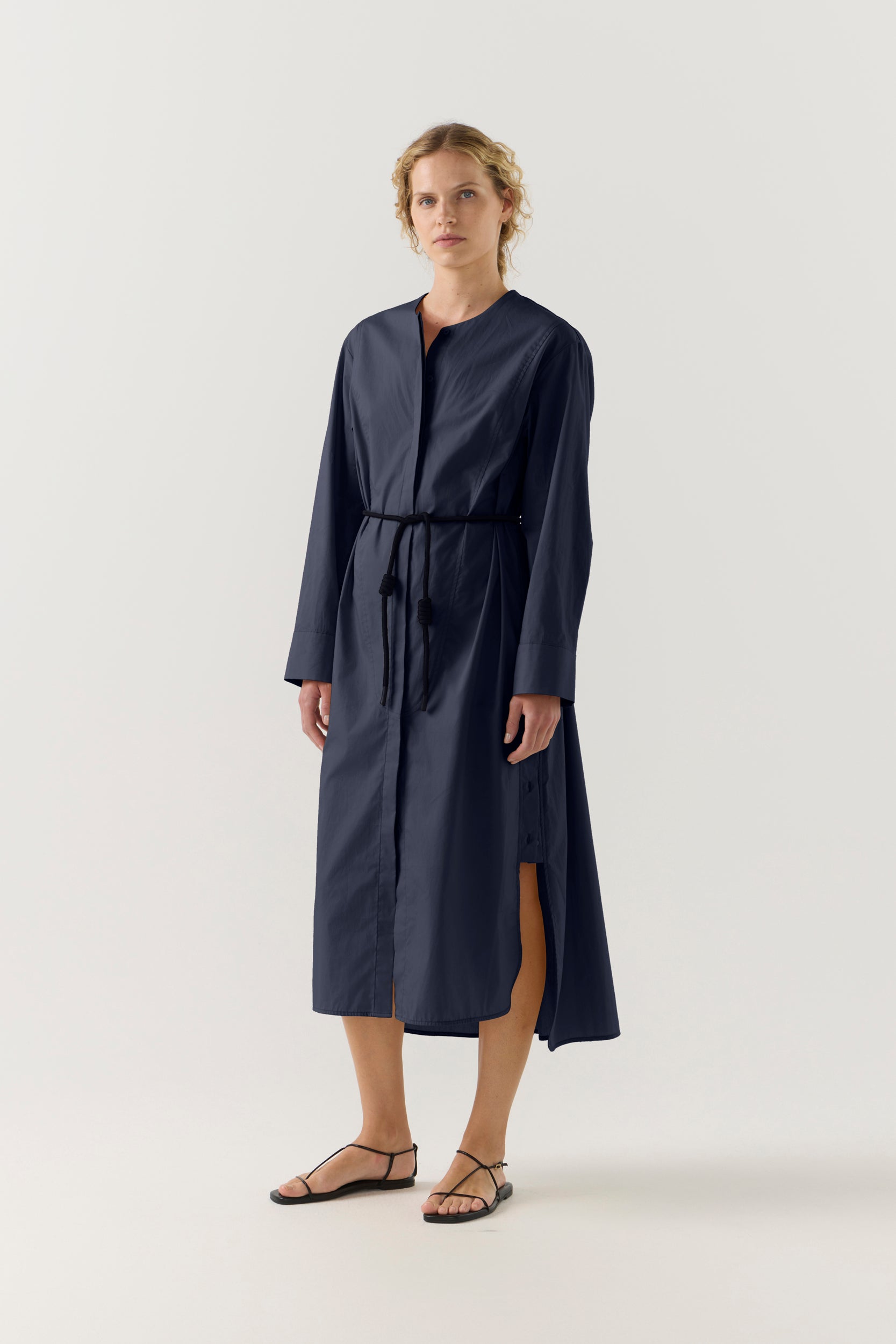 Woman wearing a dark blue dress on a white background