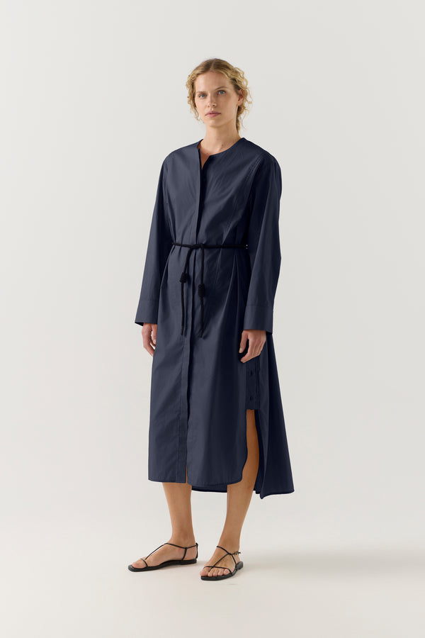 Woman wearing a dark blue dress on a white background