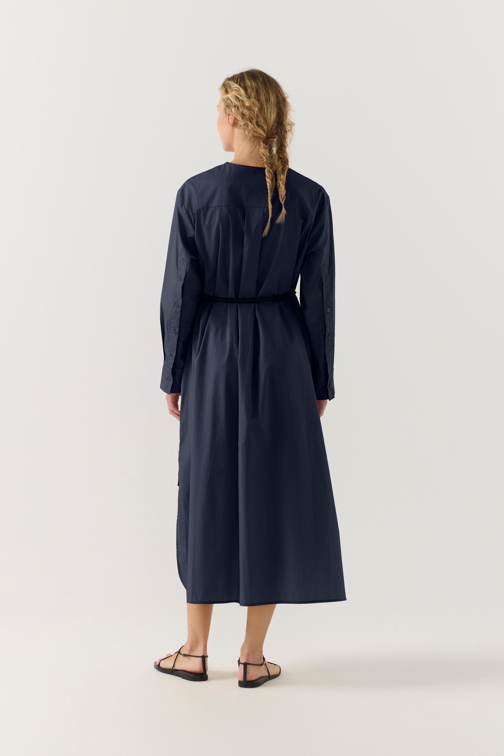 Woman wearing a dark blue dress on a white background