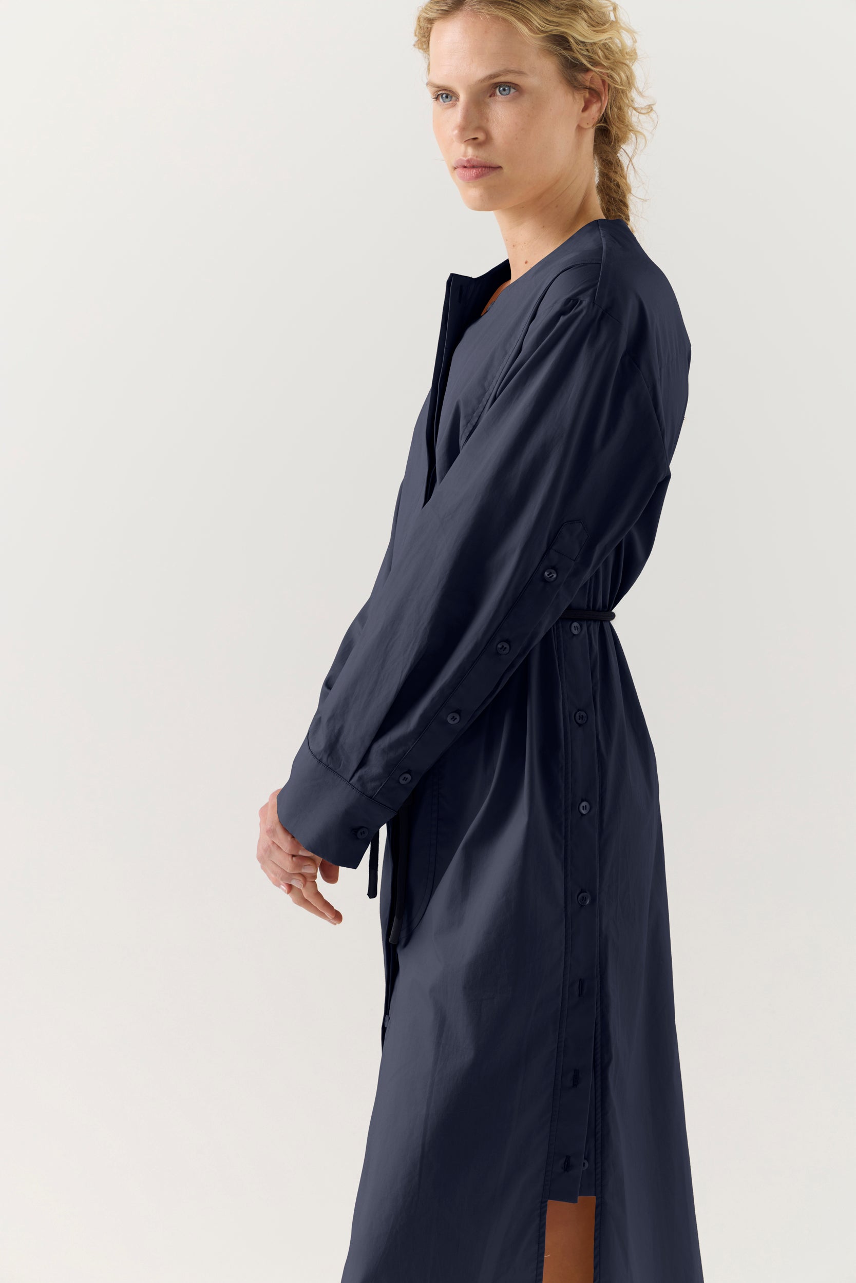Woman wearing a dark blue dress on a white background