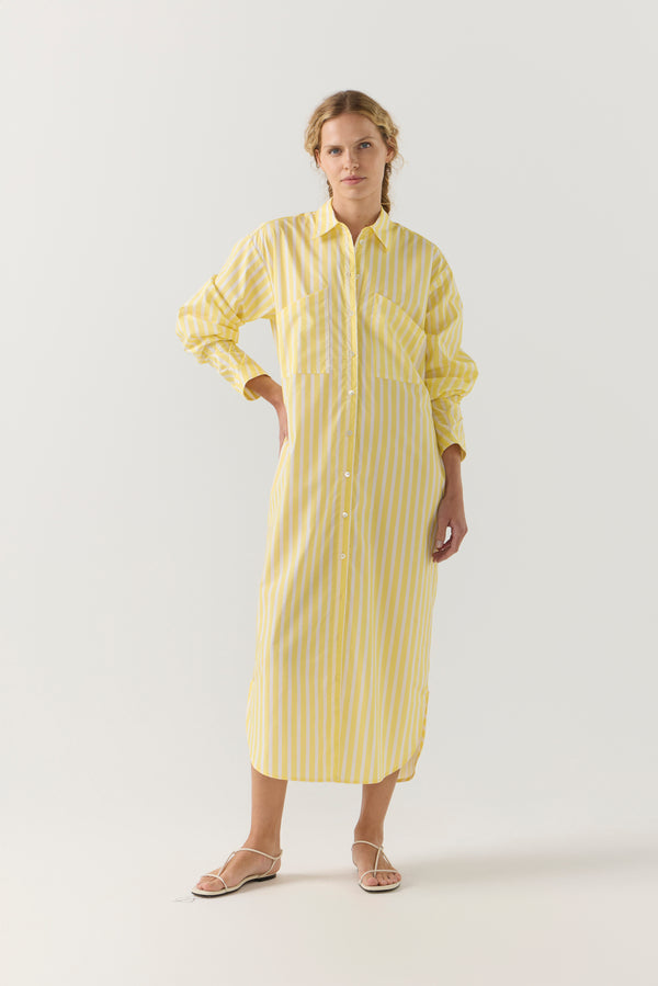Woman wearing a yellow striped shirt dress on a white background