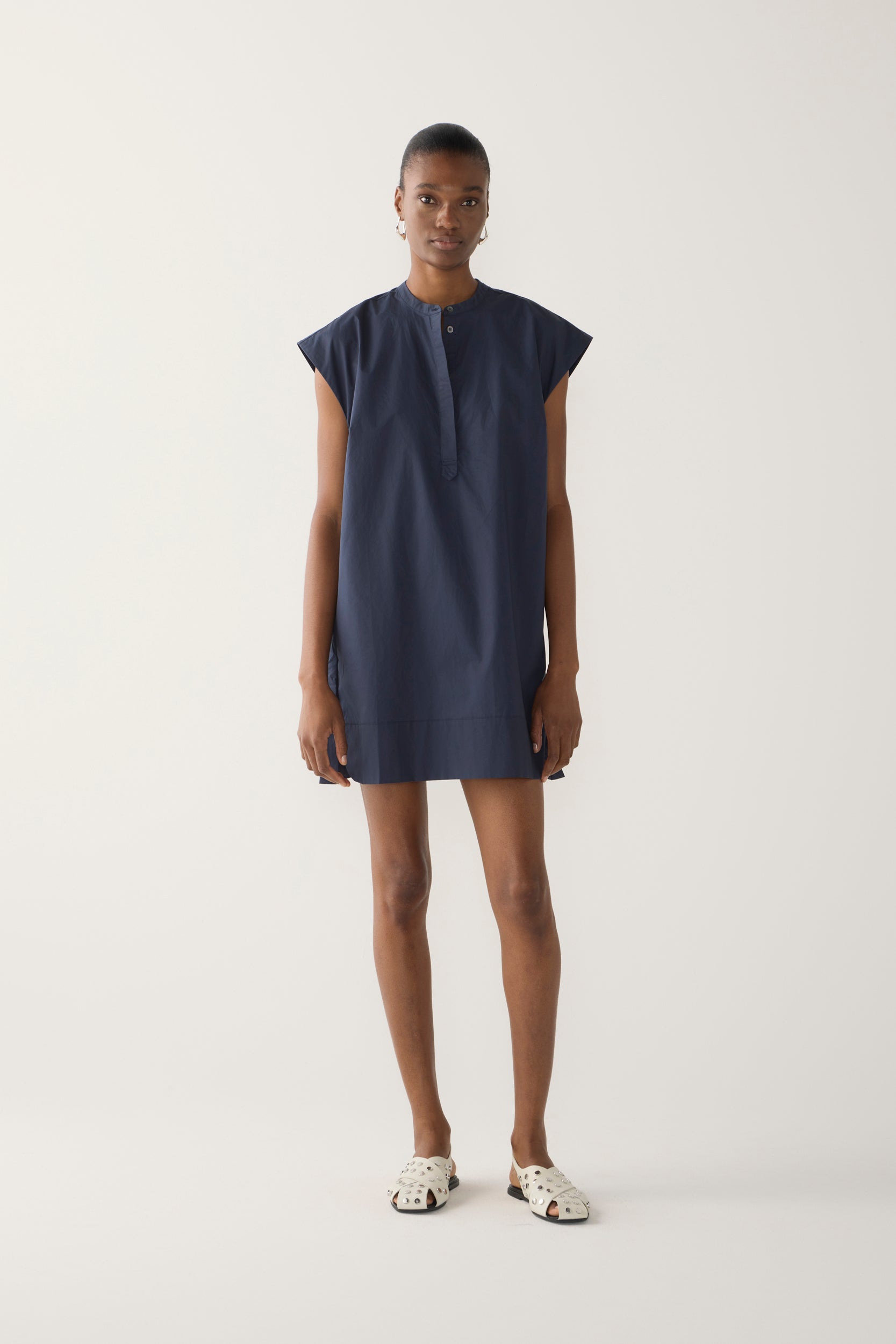 Woman wearing a navy blue dress on a white background
