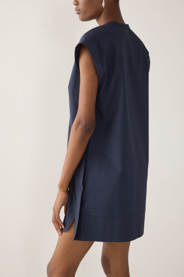 Woman wearing a navy blue dress on a white background