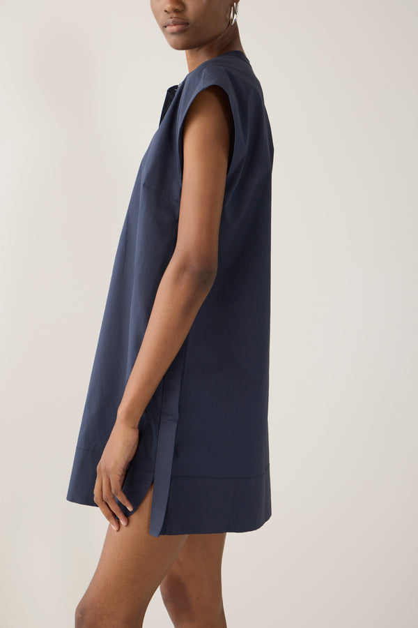 Woman wearing a navy blue dress on a white background