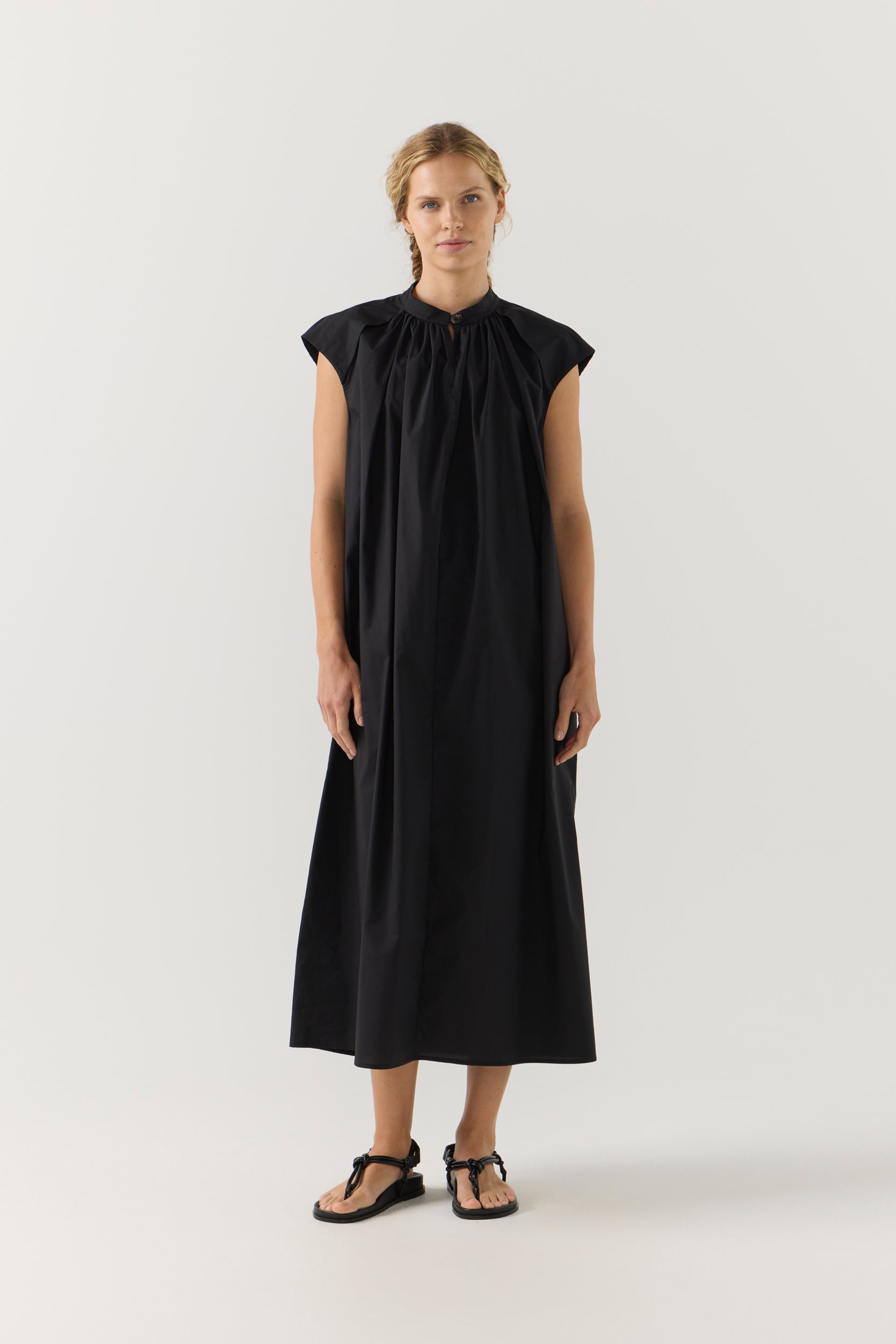 Woman wearing a black dress on a white background
