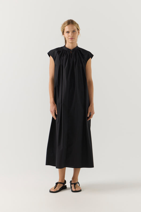 Woman wearing a black dress on a white background