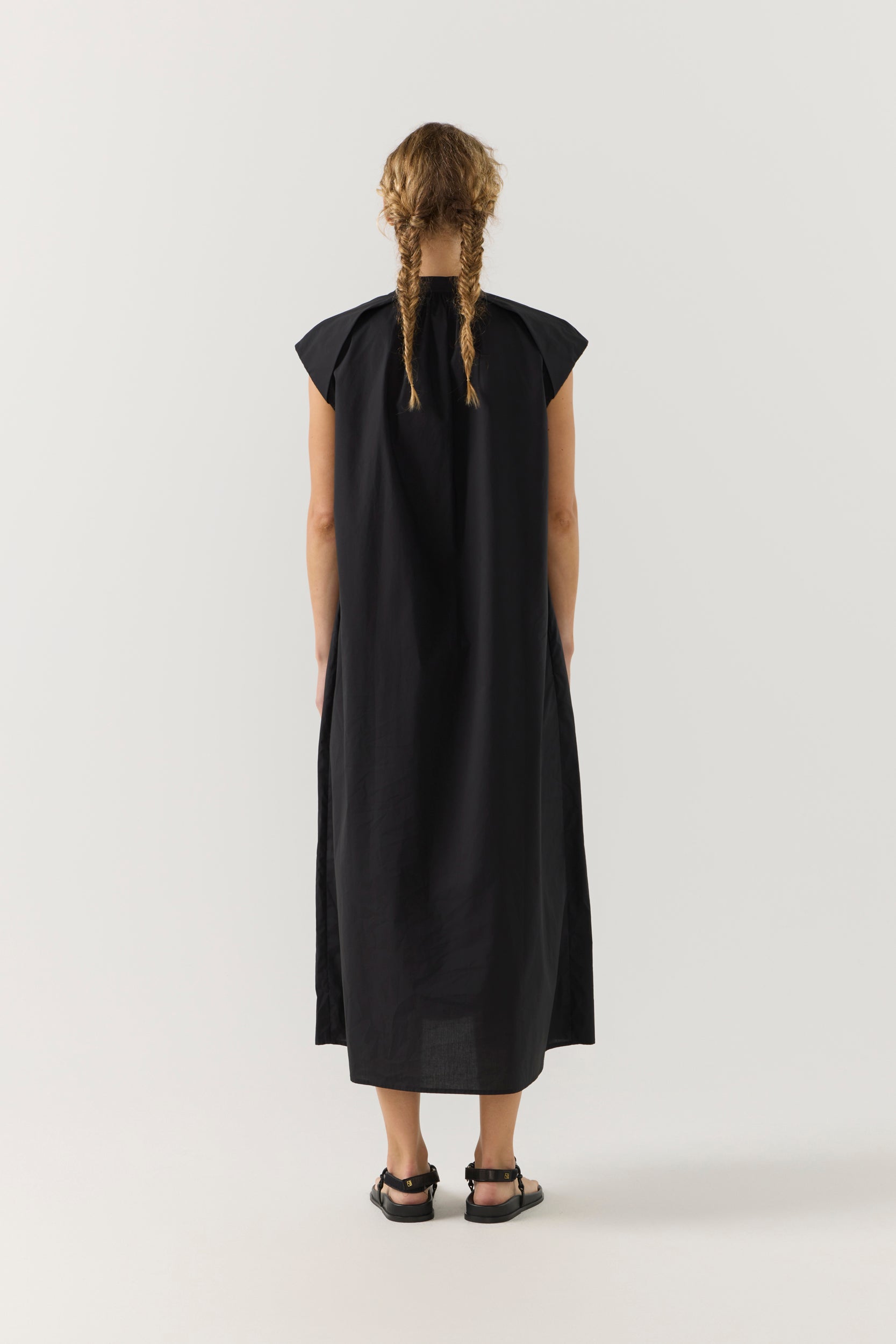 Woman wearing a black dress on a white background
