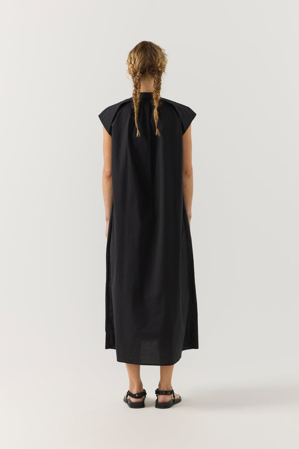 Woman wearing a black dress on a white background