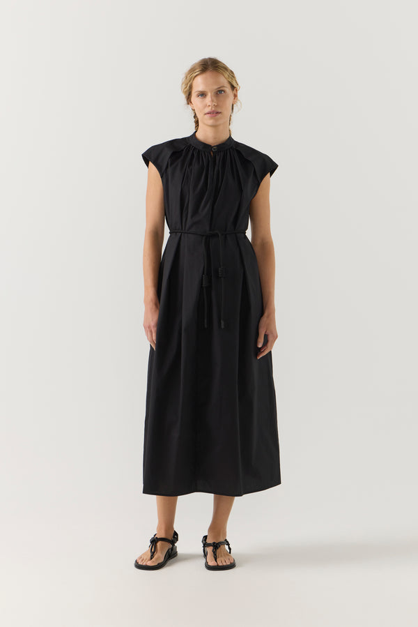 Woman wearing a black dress on a white background