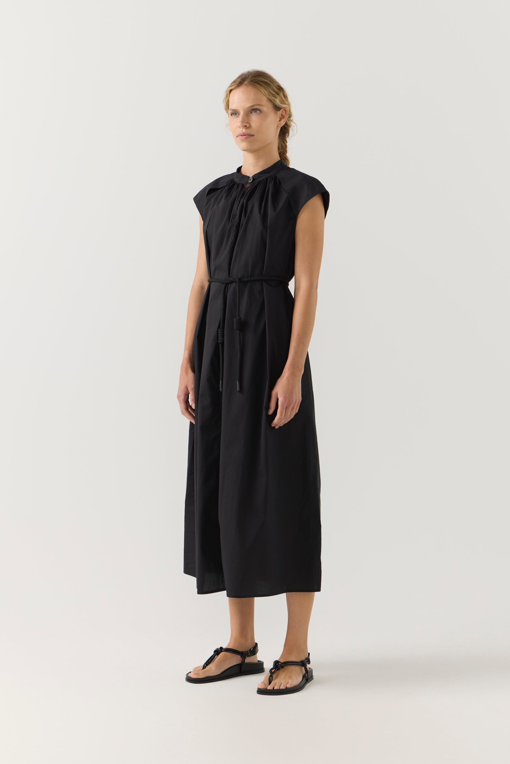 Woman wearing a black dress on a white background
