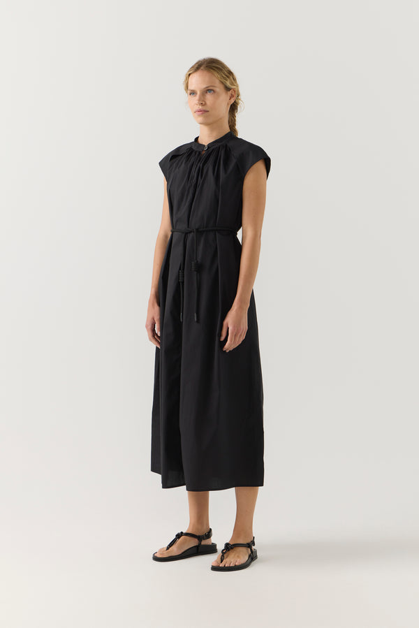 Woman wearing a black dress on a white background