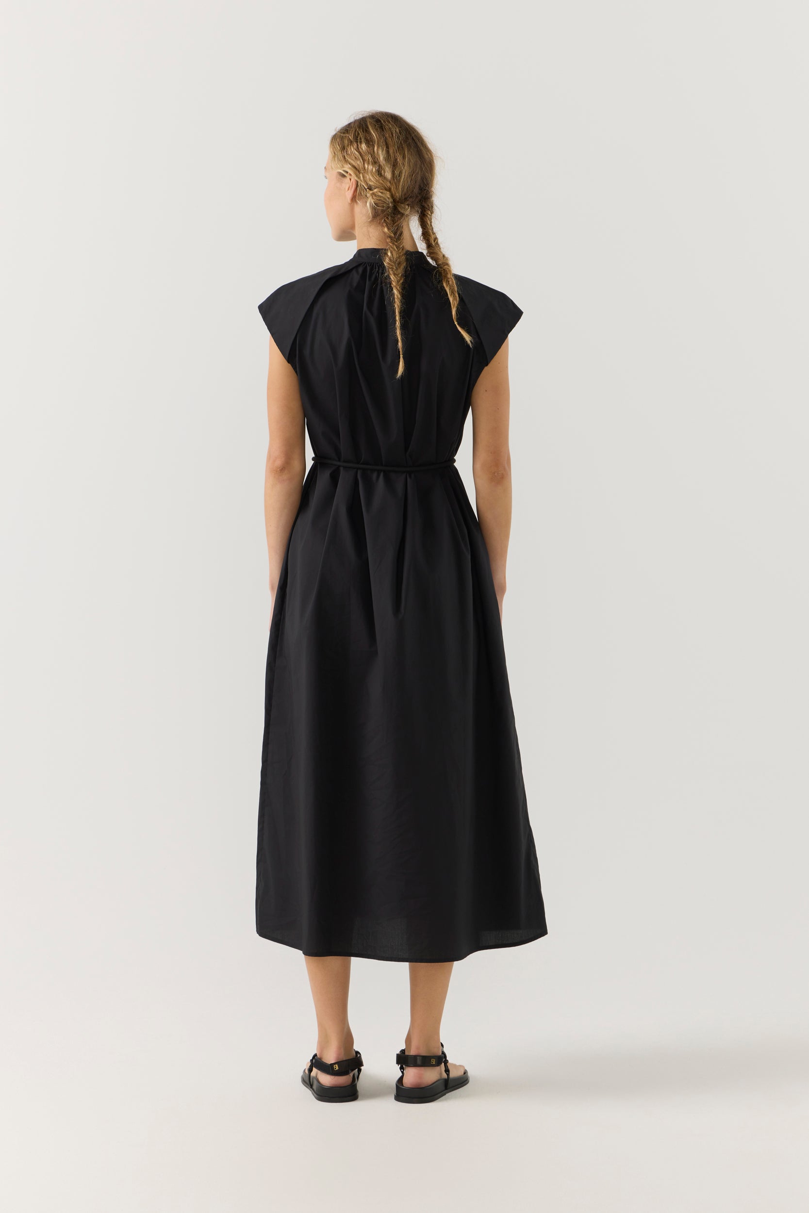 Woman wearing a black dress on a white background