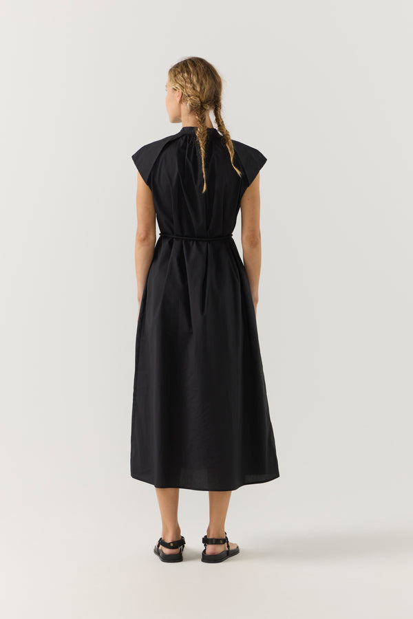 Woman wearing a black dress on a white background