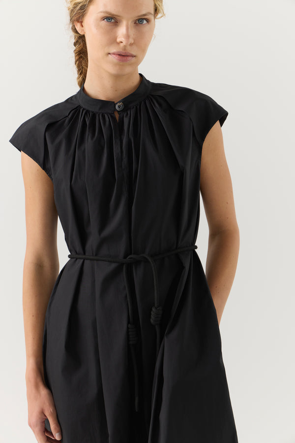 Woman wearing a black dress on a white background