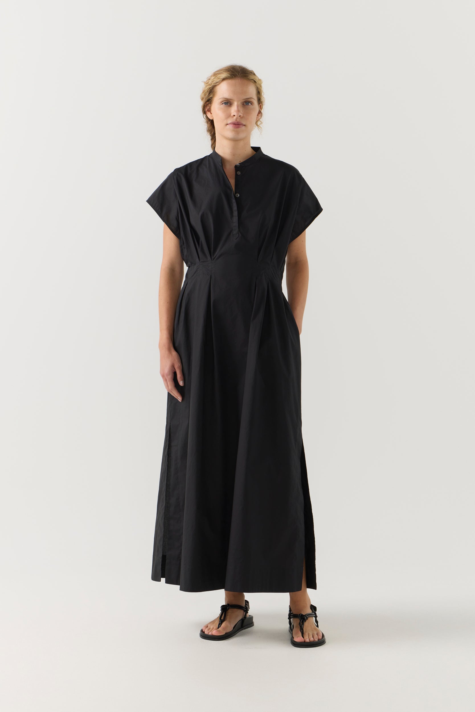 Woman wearing a black dress on a white background