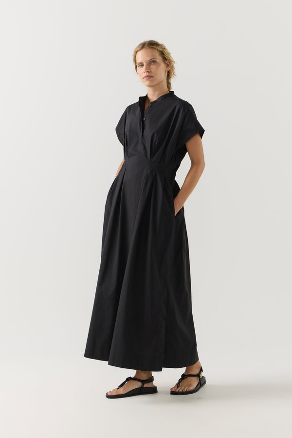Woman wearing a black dress on a white background