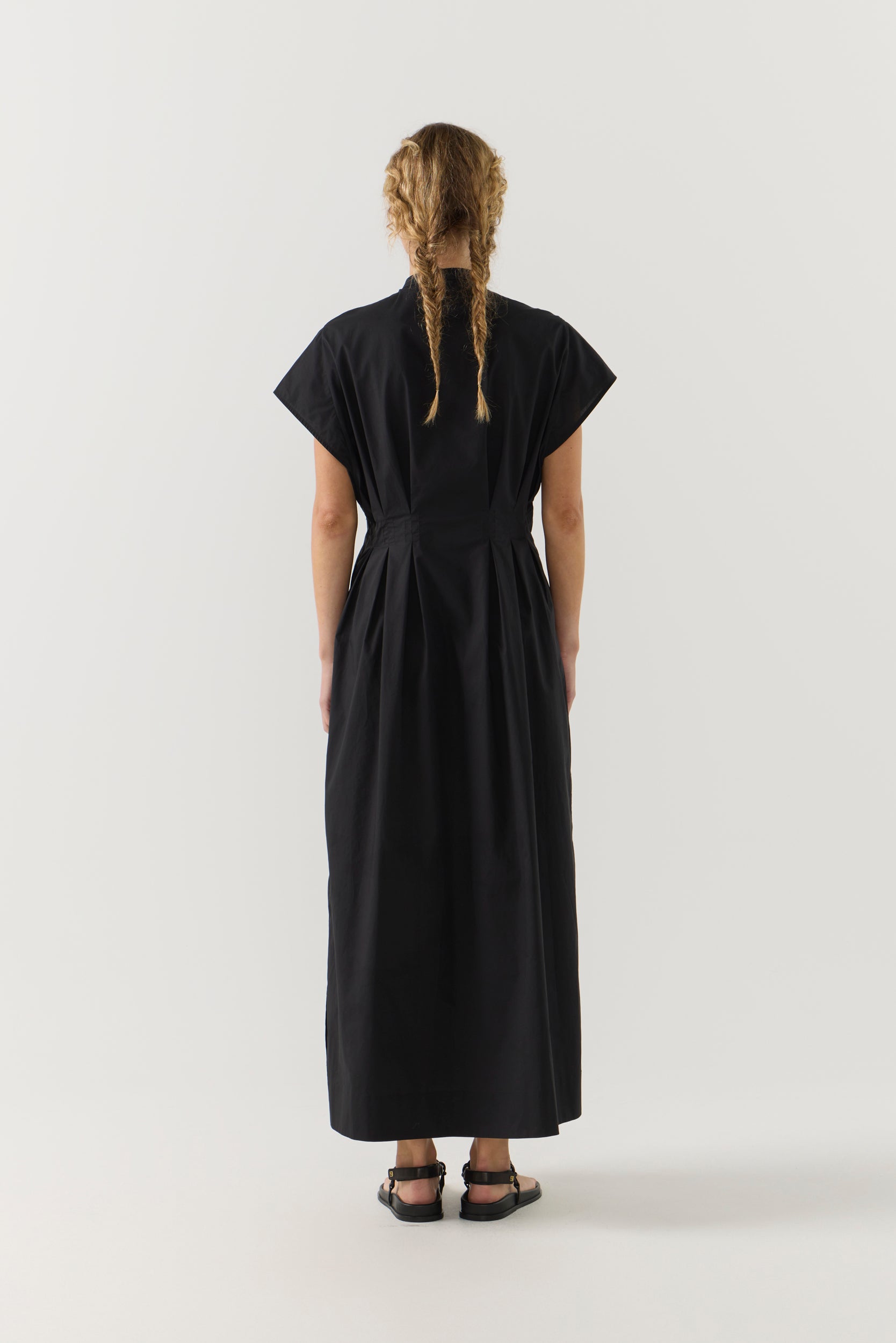 Woman wearing a black dress on a white background