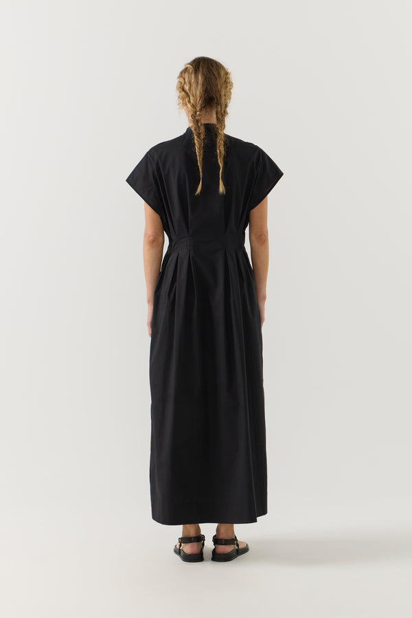 Woman wearing a black dress on a white background