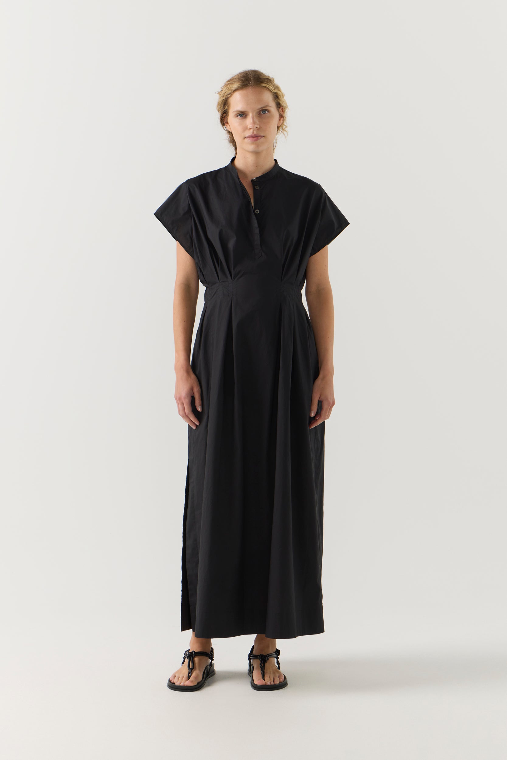 Woman wearing a black dress on a white background