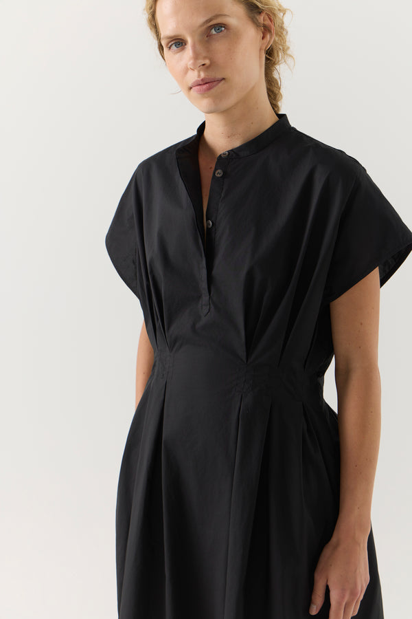Woman wearing a black dress on a white background