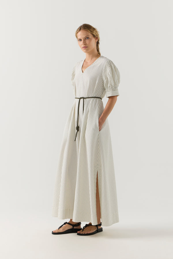 Woman wearing a white and green striped dress on a white background