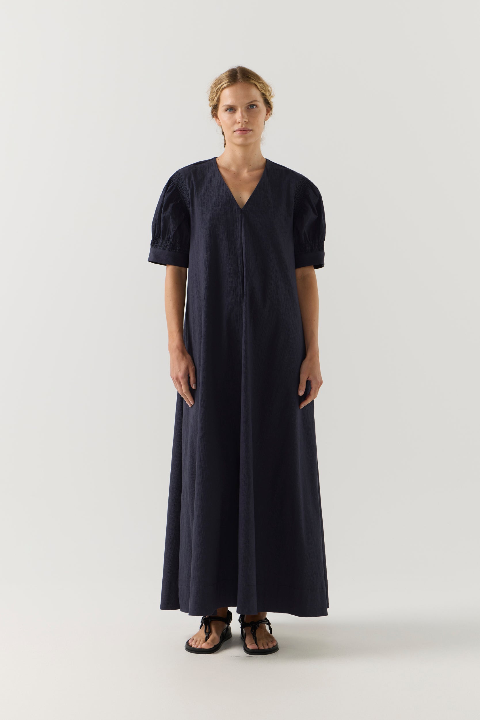 Woman wearing a black dress on a white background