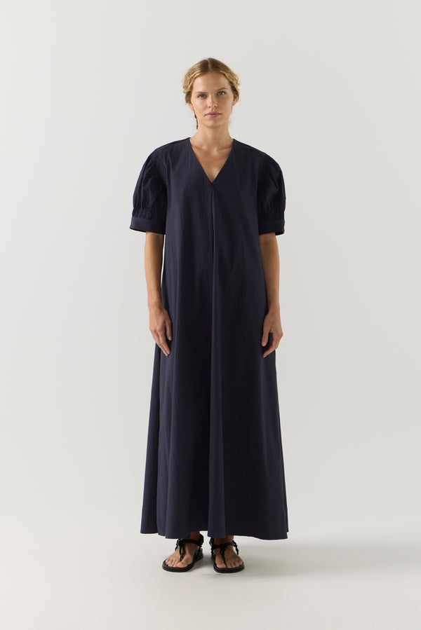 Woman wearing a black dress on a white background