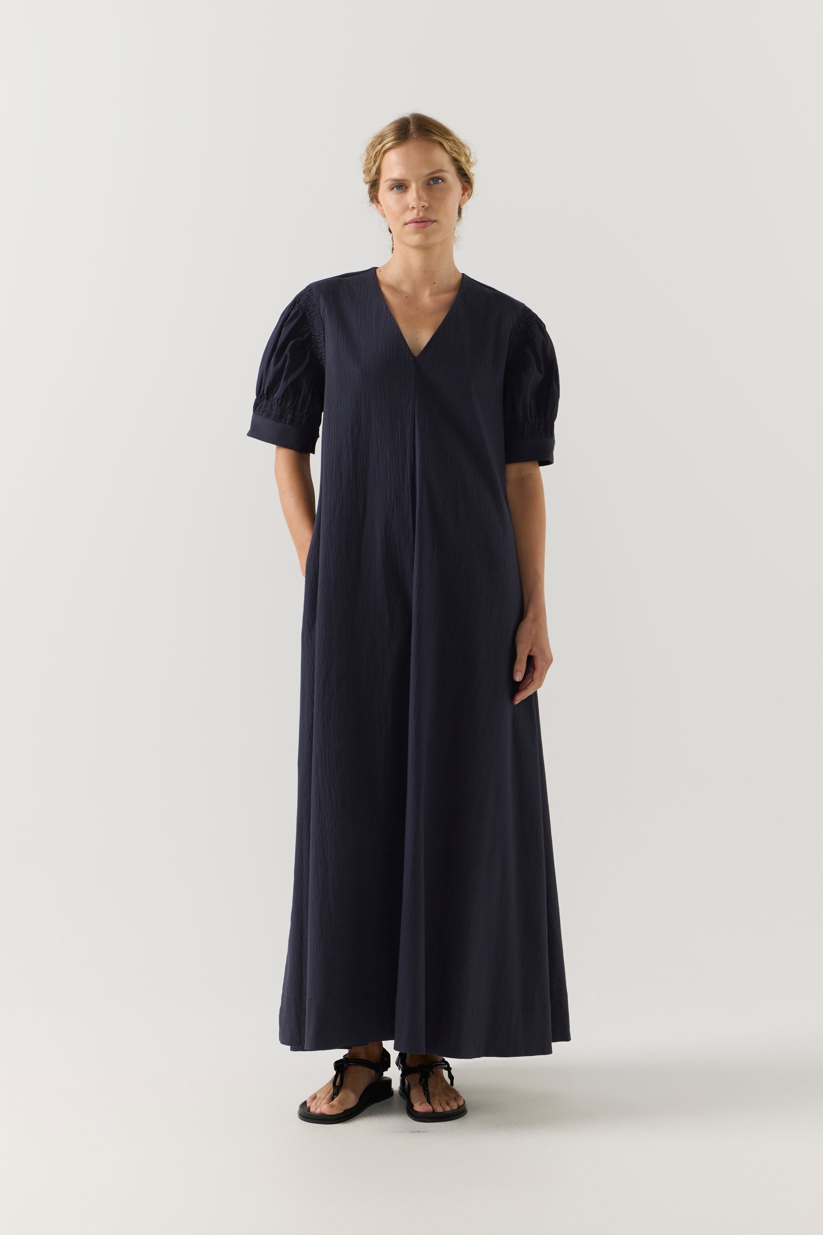 Woman wearing a black dress on a white background
