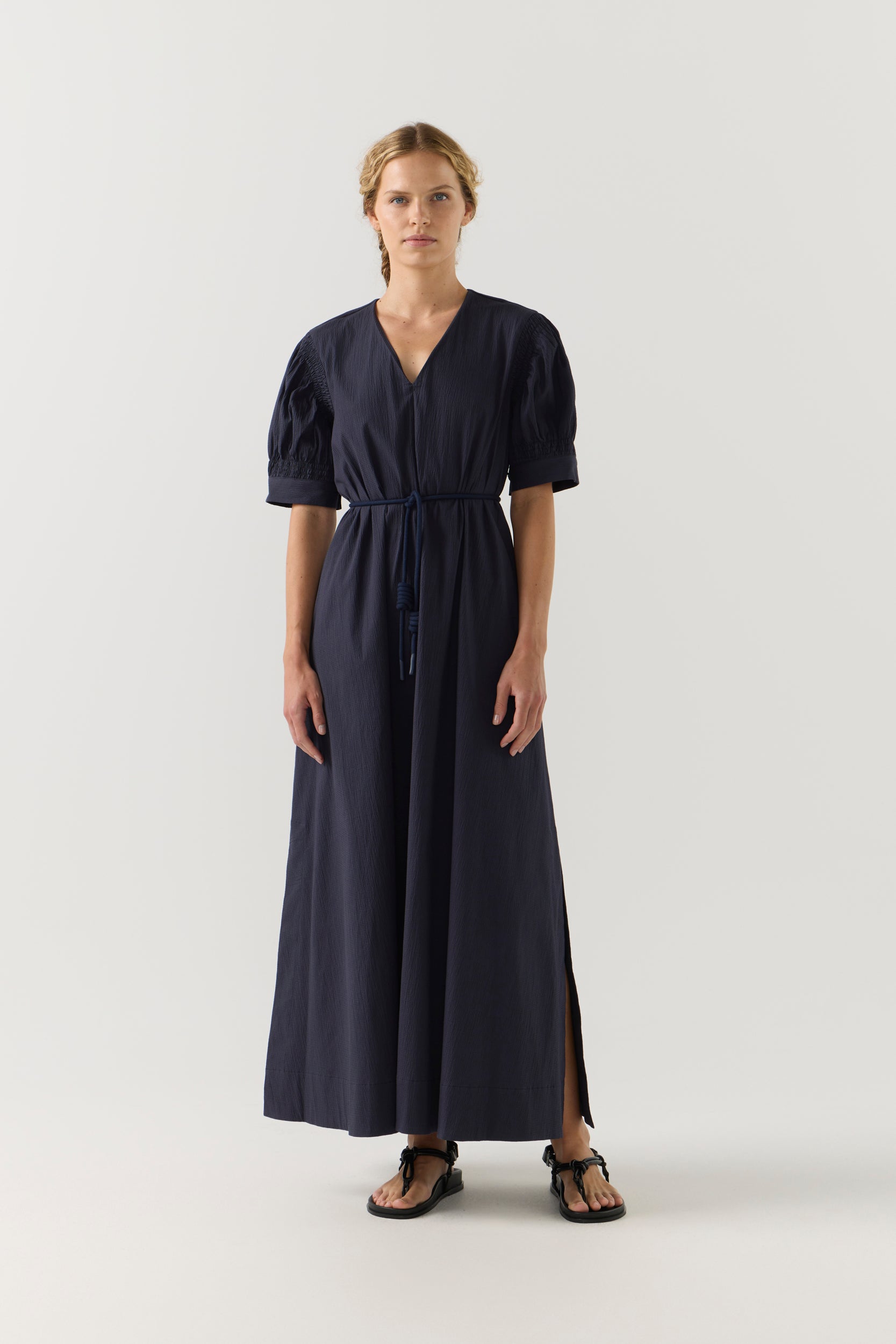 Woman wearing a black dress on a white background