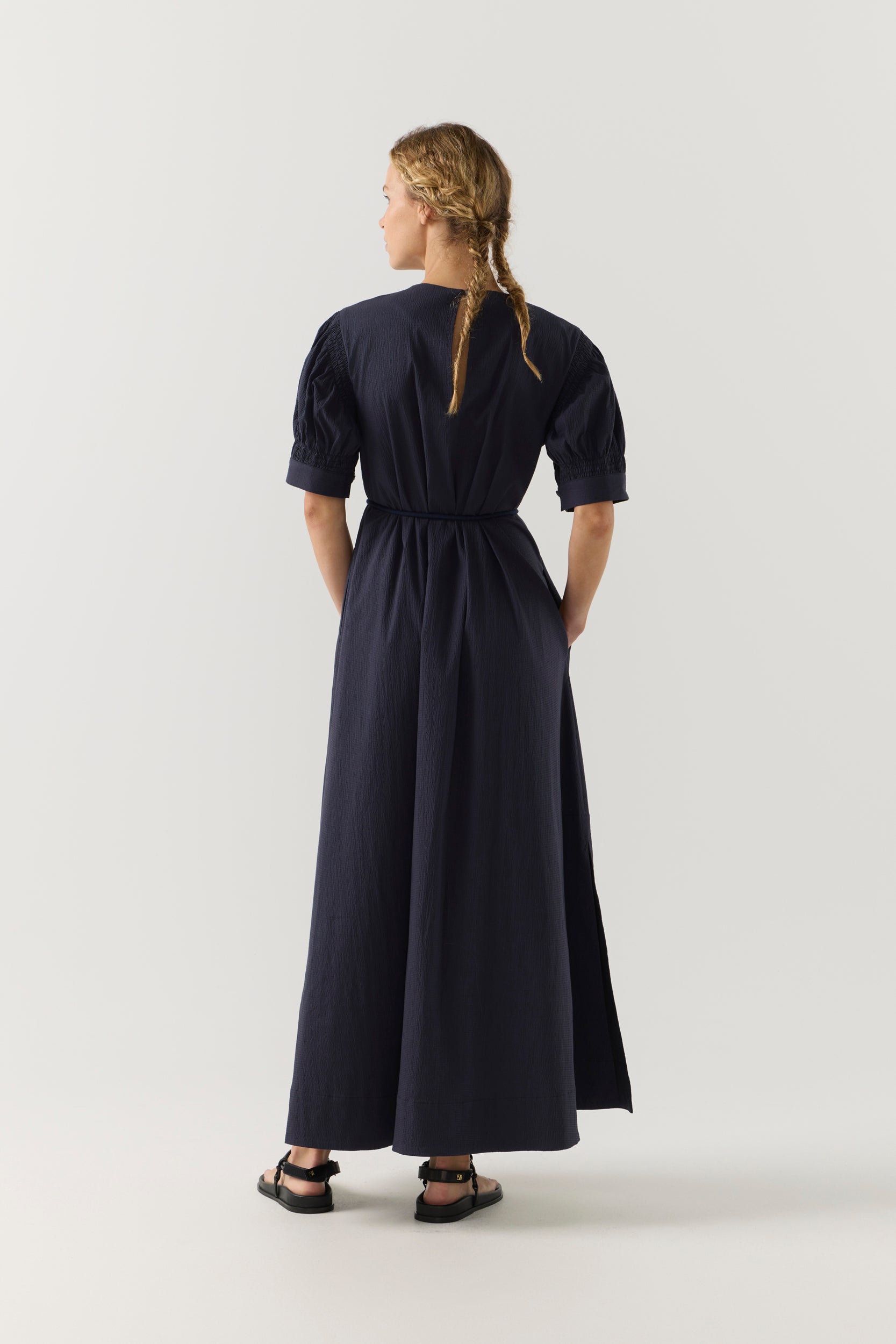 Woman wearing a black dress on a white background