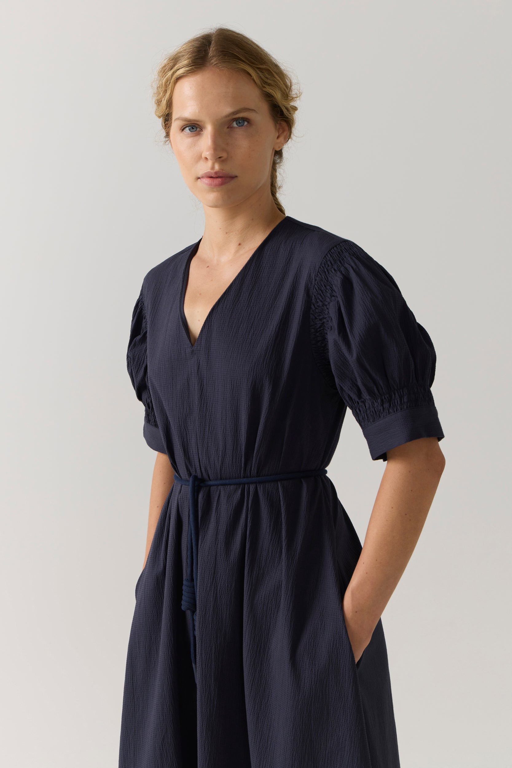 Woman wearing a black dress on a white background