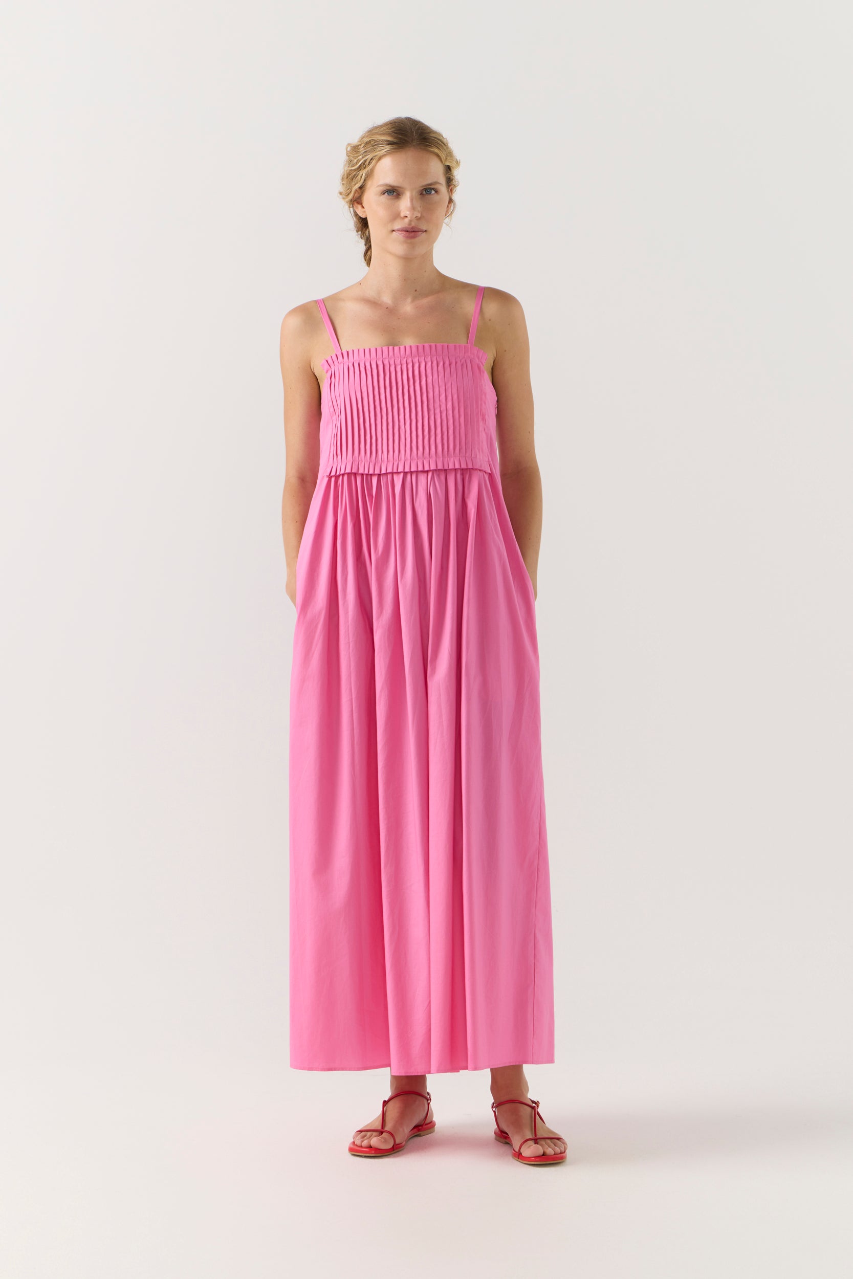 Woman wearing a pink dress on a white background