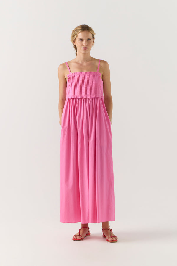 Woman wearing a pink dress on a white background