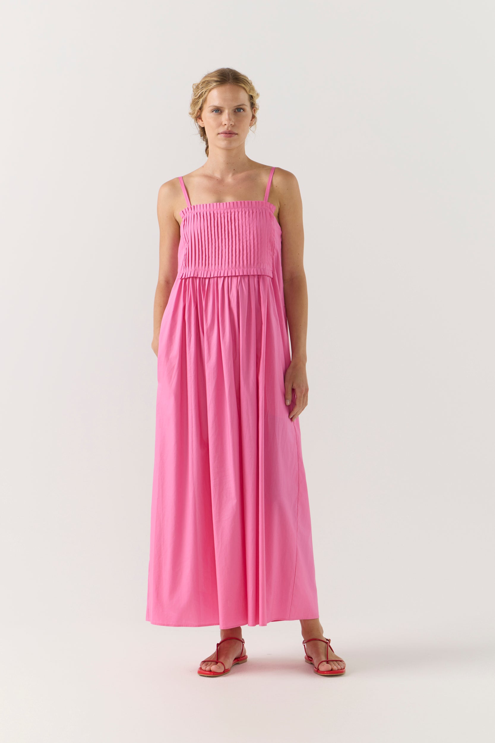 Woman wearing a pink dress on a white background