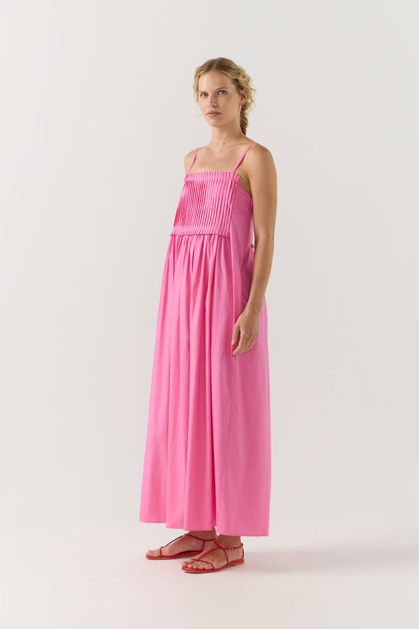 Woman wearing a pink dress on a white background