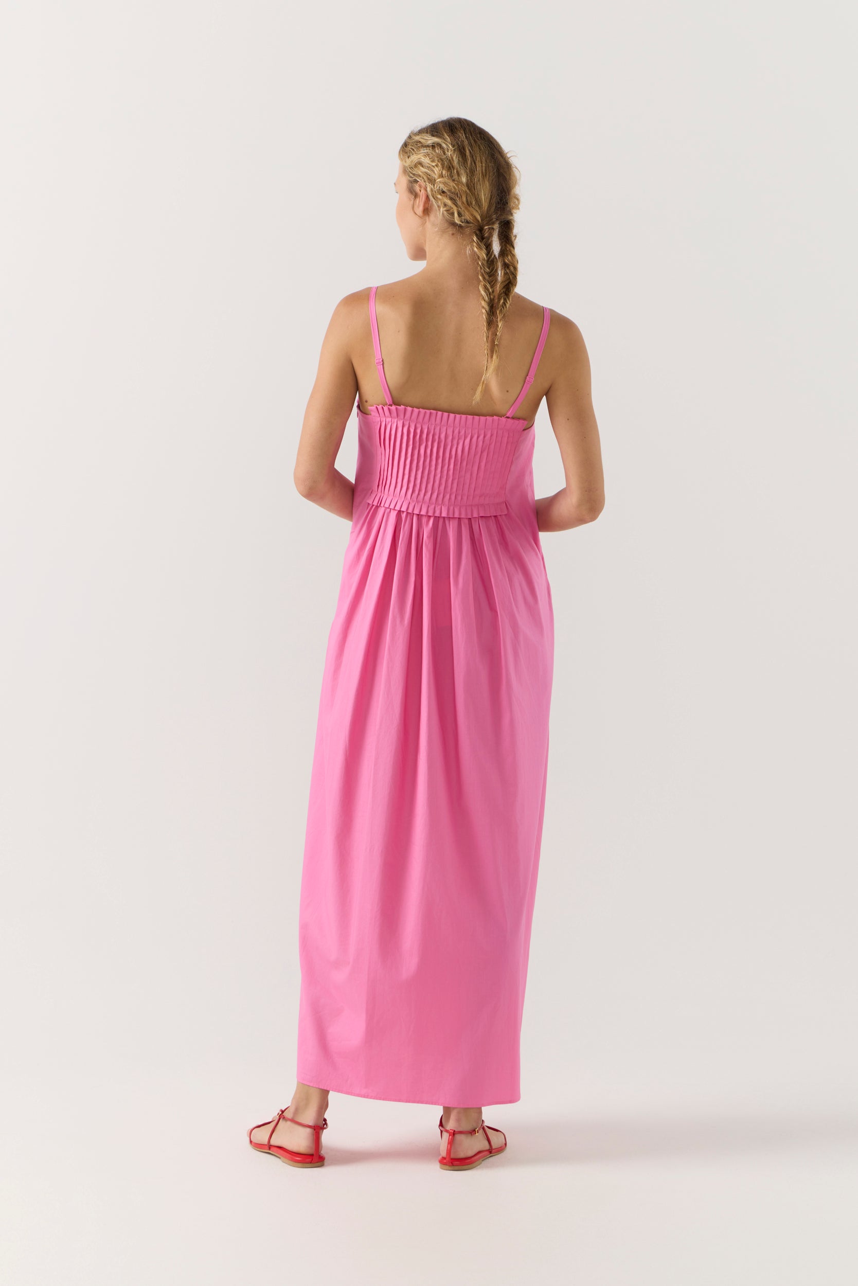 Woman wearing a pink dress on a white background