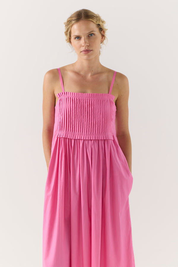 Woman wearing a pink dress on a white background